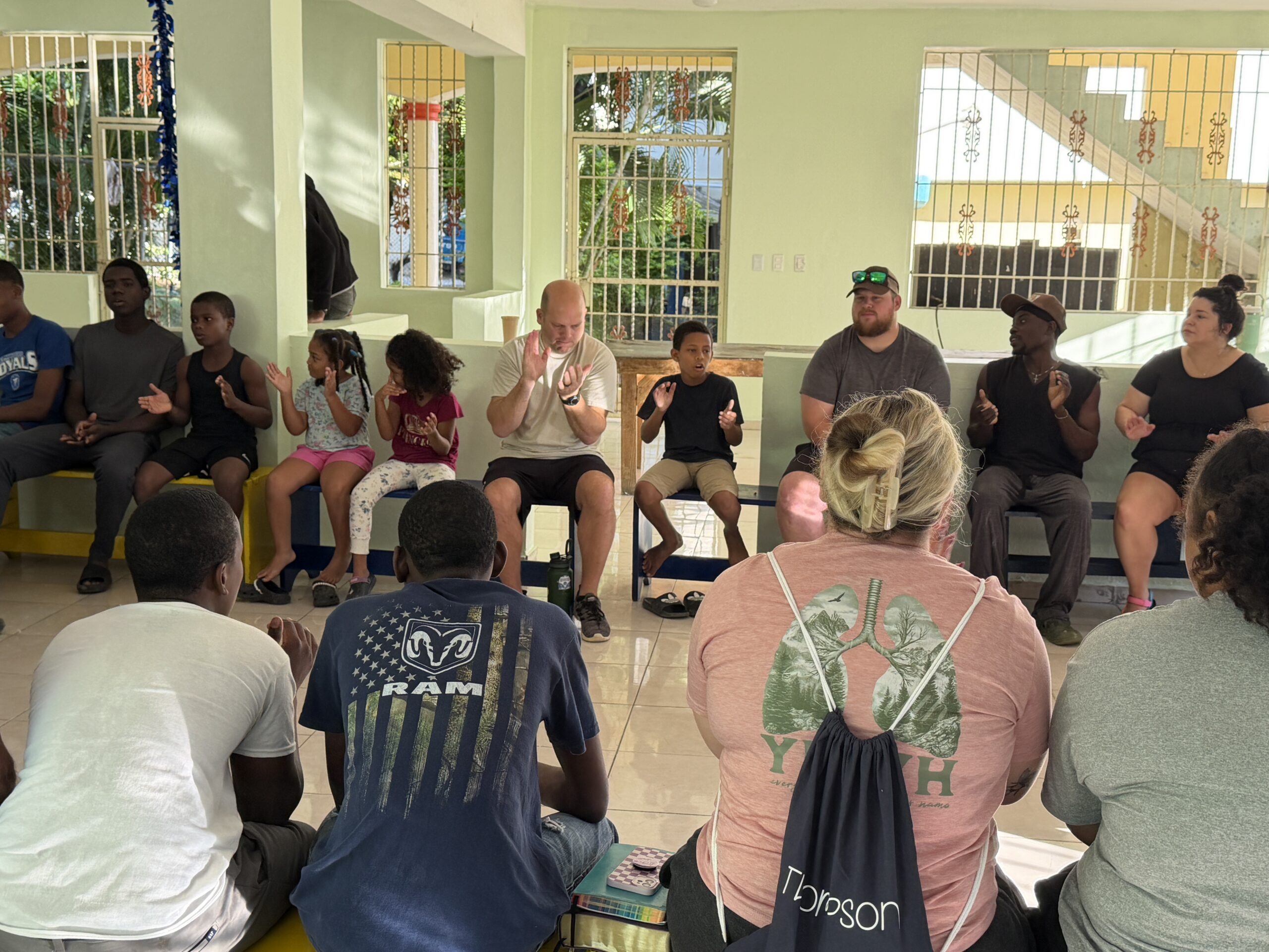 Children at helping hands orphanage praying